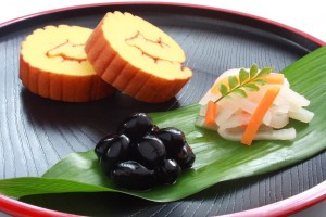 "Datemaki", stewed black bean, and "Kohaku-namasu" (red-and-white salad).